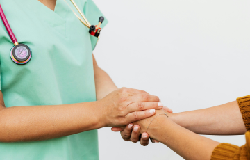 doctor and patient holding hands