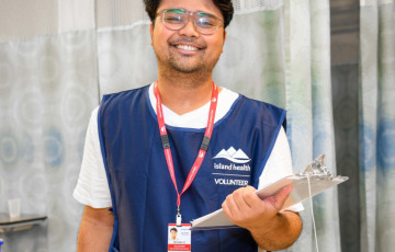 happy volunteer with clipboard in clinical setting